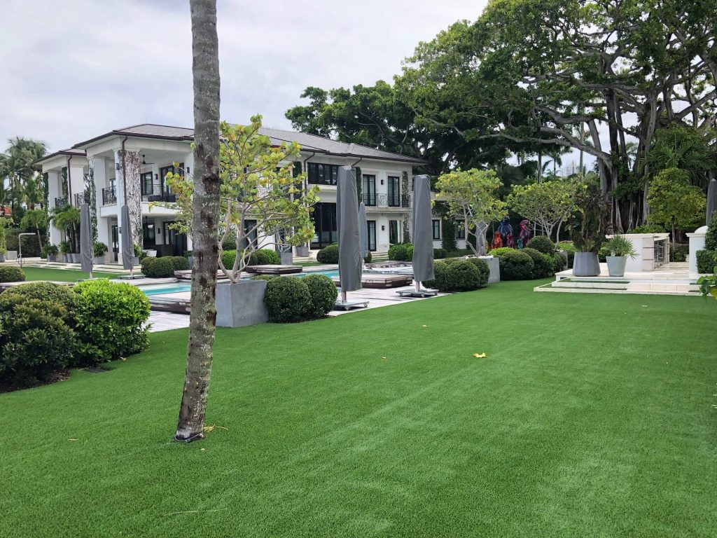 Synthetic Lawns in West Palm Beach with a house in the background